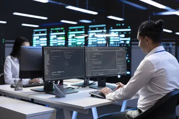 stock image Technicians in data center workspace running system diagnostic tests and error checking utilities to fix problems. Employees looking for network issues affecting rigs performance and connectivity