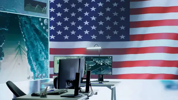 stock image Empty operations center with an American flag working on national safety, armed forces protecting the country with anti terrorism tactics. Military control and command room headquarters. Camera A.