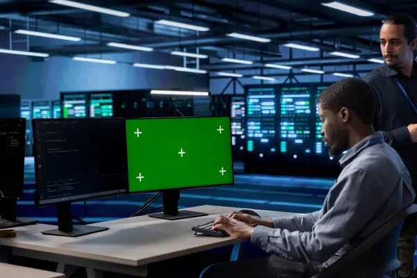 stock image Engineer in server hub using green screen computer to find firewall misconfigurations affecting performance. Worker checking systems bottlenecks leading to sluggish data transfer rates using mockup PC