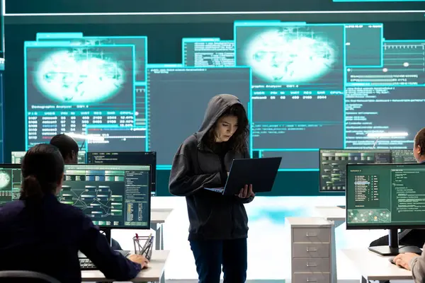 stock image Governmental hacker examines info on a big screen in agency office, using advanced technology to secure computer networks. Working on cyber security and defending against cyberwarfare.