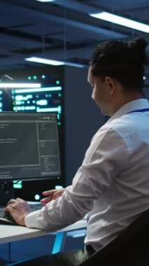 Yüksek teknoloji veri merkezi kurulumundaki dikey video mühendisleri bilgisayara yazılım yüklüyorlar, sorun yaratma sorunları. Bilgi işlem uzmanları sunucu odasında performans kriterleri oluşturuyorlar