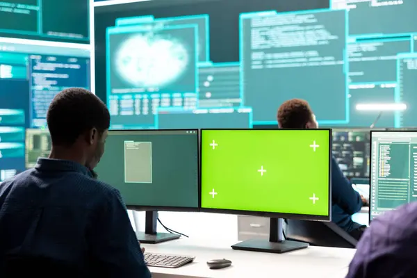 stock image Governmental hackers working on computer with green screen to protect data and network security. Focusing on cyber defense, malware detection to prevent cyber attacks and espionage.