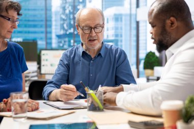 Mature person signing a contract with insurance agency banker, agreeing to the new pension plan contract with expert. Retired man collaborating with advisor to secure his life savings. clipart