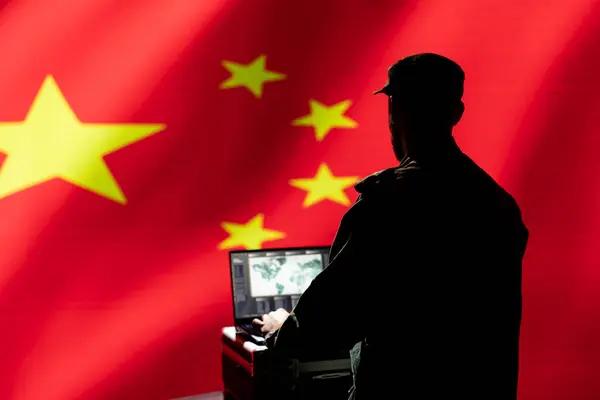 stock image Chinese army specialist working for CCP government using target acquisition tech on laptop to detect enemy location. Military officer isolated over Republic of China flag using satellite device