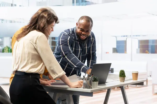 stock image Salesman and contractor meeting with client to evaluate office space layout on blueprints in order to enhance her workspace vision. Experts assisting entrepreneur with property investment.