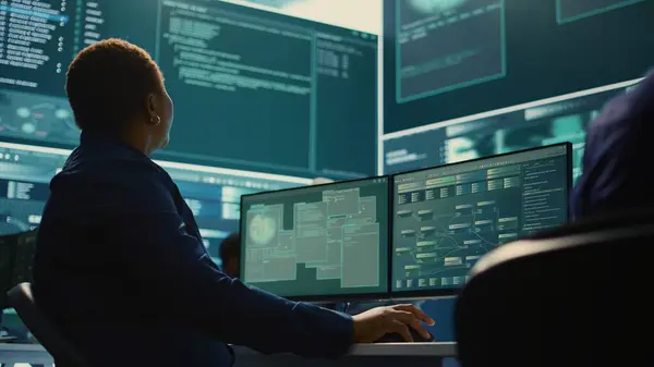 stock image Cyber security expert working on encryption and IT security in a governmental agency. Woman engaging on cyber operations, network security and data protection for hybrid war. Camera B.