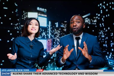 Show hosts reveal wisdom from aliens sharing advanced technology and practises with humans, ufo landing. Diverse newscasters team presenting important information regarding invasion. clipart