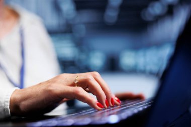 Senior IT specialist using laptop, ensuring valuable data remains shielded from potential dangers, safeguarding server clusters against unauthorized access and vulnerabilities, close up clipart