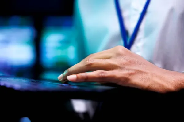 stock image Extreme close up shot of employee using laptop in data center providing vast computing resources and storage. Blade servers enabling ai to process massive datasets for training and inference