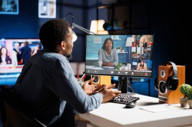 Şirket yöneticisi, çalışanları evden çalışırken video bağlantısı toplantısına katılarak idari görevler hakkında tavsiyelerde bulunuyor. Çevrimiçi aramada, Afrikalı Amerikalı adam iş arkadaşlarıyla konuşuyor..