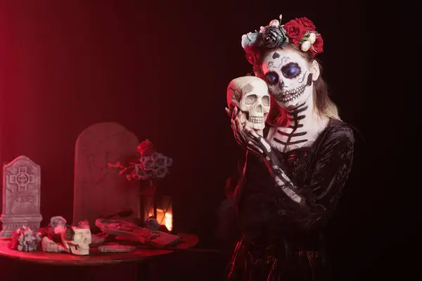 stock image Eerie lady hugging skull at religious processions during Dia de los Muertos november holiday. Woman showing reverence for deceased family members by doing loving gesture towards skull