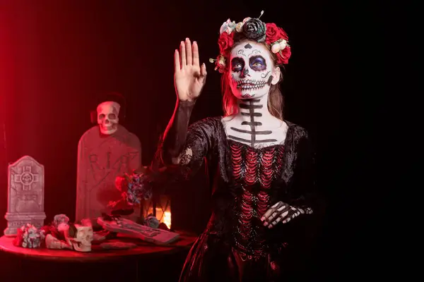 stock image Woman using augmented reality tech at Day of the Dead event to remember the deceased. Lady swiping on AR hologram during Mexican holiday of remembrance for those who have passed