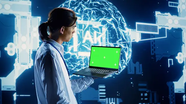 stock image Programmer using chroma key laptop to implement artificial intelligence parallel processing. Admin working on green screen device, enabling AI systems to process machine learning data