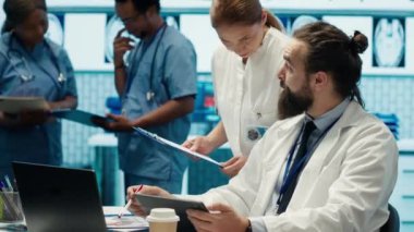 Sağlık uzmanları tedavi planları, takım çalışması ve radyoloji uzmanlığı geliştirmek için insan anatomisi taramalarını inceliyor. Tıp uzmanları özel tesiste analitik üzerinde çalışıyorlar. Kamera A.