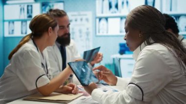 Pratisyen hekimler test sonuçları, tedavi seçenekleri ve takım çalışması konusunda personelle işbirliği yapar. Bir tesiste uzman doktorlara danışmak ve hastalıkların önlenmesini desteklemek. Kamera B.
