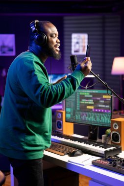 Yetenekli şarkıcı akustik şarkısı için bir kayıt seansı yapar, mikrofon ile ev stüdyosunda şarkı söyler. Kendine güvenen müzisyen yeni yeni parça kayıtları üzerinde çalışıyor..