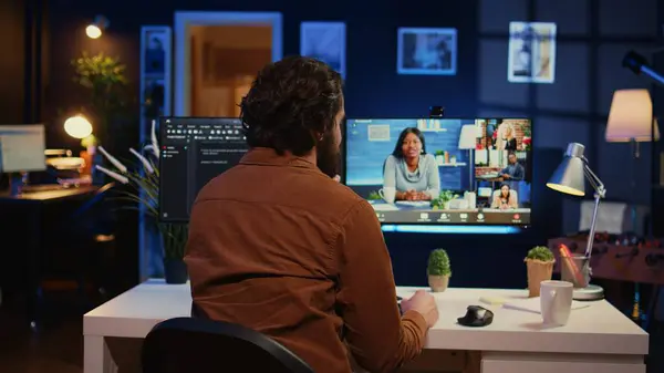 stock image Teleworking software engineer talking with colleagues during internet videocall, discussing ways to fix programming bugs. IT admin in videoconference meeting with coworkers, camera B