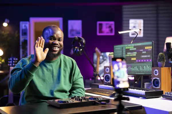 stock image Sound technician instructor hosting an online master class to teach people how to use a mixing console in post production. Using motorized faders and pre amp knobs for a demonstration.