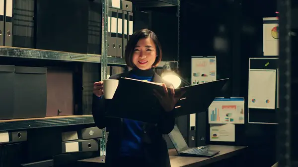 stock image Portrait of investigator tracking financial transactions registered in the archives folders, looking for similarities and clues on criminology documents. Law agent working on forensics. Camera A.