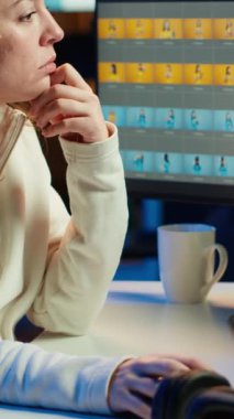 PC ekranında profesyonel fotoğraf düzenleme araçları kullanan dikey video fotoğrafçısı. Fotoğraf editörü, bilgisayar ekranı ve kamera kullanarak ayarlamalar yapmak için yüksek teknolojili fotoğraflar kullanıyor.