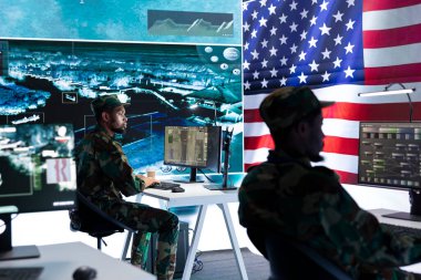 US military officer supervising threat detection activity in high tech office, examining top secret data on big screen. American army soldiers managing hybrid war, cyber attack prevention. clipart