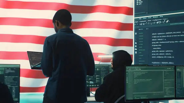 Stock image A technical team in a governmental cyber environment with the USA flag. Focus on cybersecurity strategy, threat management and secure operations for national security and digital defense. Camera A.