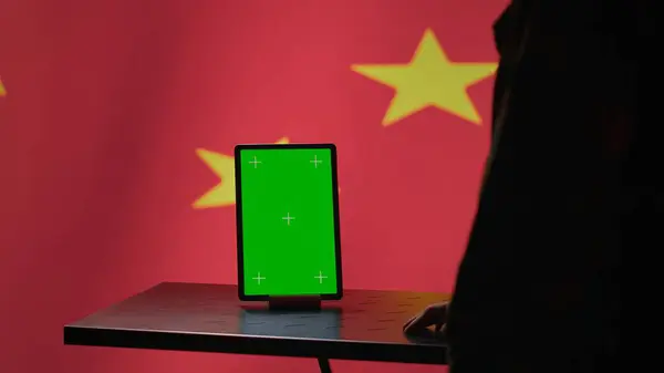 stock image Chinese engineer uses green screen tablet to make fake accounts on social media promoting communist ideology. Technician doing cybersecurity job for CCP government with mockup device, camera A