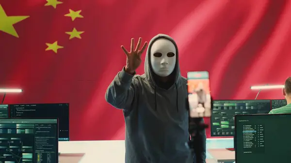 stock image Chinese anonymous criminal recording himself asking for ransom, hacking intelligence systems and spreading false information, misleading. Autocracy communism doctrine in hybrid war. Camera A.