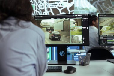 Agency employee monitoring the delivery trucks shipping activity, following routes via gps tracking on satellite map. Woman works on guiding couriers to avoid heavy traffic and delays. clipart