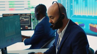 İş yerlerindeki iş akışı istatistiklerini kullanarak büyük bir veri ekranında yıllık bilgi grafiklerini inceleyen hava tahminleri ekibi. Çeşitli şirket çalışanları son bütçe planlarını inceliyor. Kamera A.