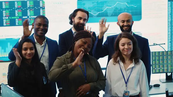 stock image Confident smiling enterprise team uniting their forces to improve workflow and efficiency, achieve organizational goals. Diverse group of analysts work in telecommunications control room. Camera A.