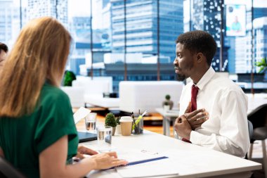 İnsan Kaynakları departmanının iş adayının şirket kültürüne uygun niteliklere sahip olmasını sağlaması. Kelle avcısı, Afrika kökenli Amerikalı bir adamla maaş paketi ve diğer faydaları görüşüyor.