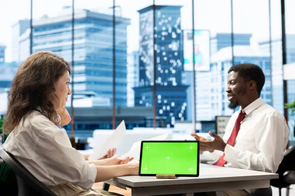 stock image HR expert works on isolated screen tablet, identifying candidates for job opening, reviewing resumes to determine candidate qualifications. Headhunter doing screening process with chroma key device