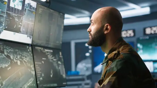 stock image Soldier doing patriotic duty in military HQ base, gathering information on enemy troops. Officer using high tech monitoring gear to do assessment of enemy vulnerabilities, camera A