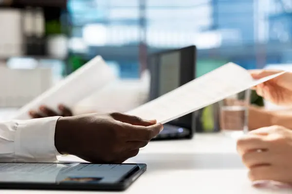 stock image HR expert reading resume, determining if candidate possesses skills and experience needed to fulfil role. Close up of employer checking applicant CV, evaluating if qualifications align with company