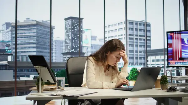 stock image Exhausted overwhelmed businesswoman with a headache trying to meet project deadline, working hard to save the reputation of her corporation. Stressed nervous leader in crisis, overload. Camera B.