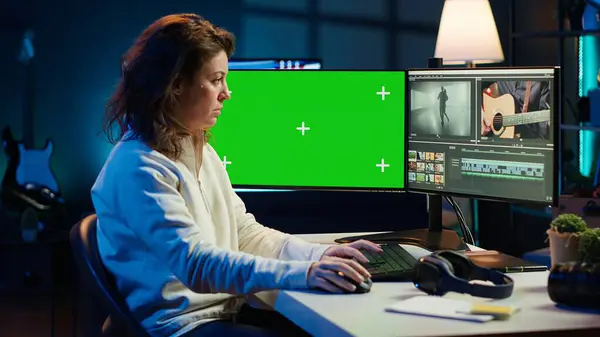 stock image Video editor using editing software on green screen monitor to upgrade footage shot, commissioned by production teams outsourcing tasks. Freelancer videographer finishes project on mockup PC, camera A