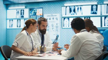 Sağlık personeli tanısal kontrol ve tedavi stratejilerinde işbirliği yapar. Radyoloji ve radyografi alanında uzman doktor, tedavi merkezinde etkili hastalıkların önlenmesini destekliyor. Kamera B.