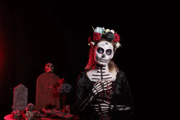 stock image Portrait of mysterious witch at religious processions during Dia de los Muertos november holiday. Woman dressed as La Catrina wearing skeleton makeup symbolizing reverence for deceased