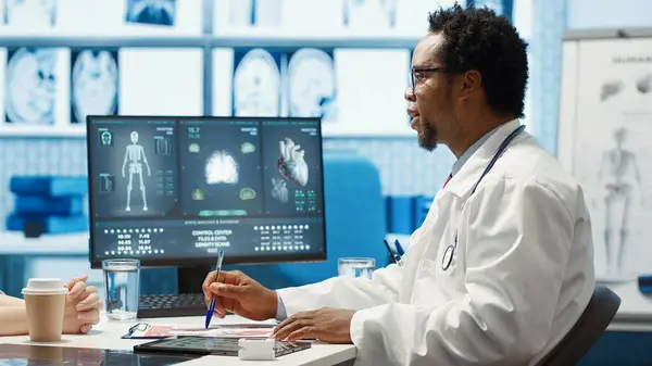 stock image Medical expert discussing about diagnostics treatment with patient in cabinet, reviewing the test analysis reports during a consultation. Medic specialist supporting woman with illness. Camera A.