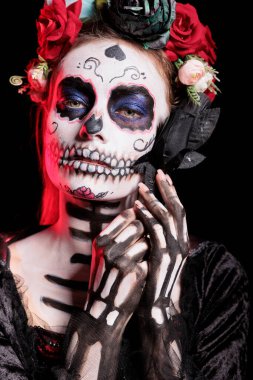 Headshot portrait of woman with flower at Day of the Dead event to remember the deceased, celebrating their memory. Lady holding black rose for Mexican holiday of remembrance for those who have passed clipart