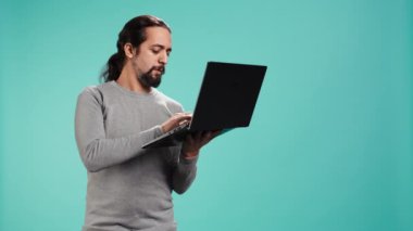 E-posta yazan, dizüstü bilgisayarda yazan, işten sonra oturumu kapatacak olan bir adam. Çevrimiçi e-posta gönderen neşeli kişi, beyin fırtınası fikri, stüdyo arka planında izole edilmiş, kamera B