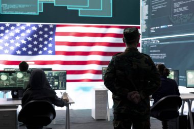 US army official working on ensuring servers protection and state secrets, protecting important hybrid warfare data in high tech agency office. Military soldier supervises hacking activity. clipart