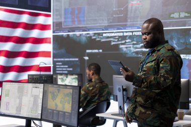 ABD askeri personeli, siber saldırılara karşı gizli bilgileri ve devlet sırlarını koruyan çağdaş bir ordu komuta merkezinde çalışıyor. Dijital savaş ve siber güvenlik operasyonlarının yönetilmesi.