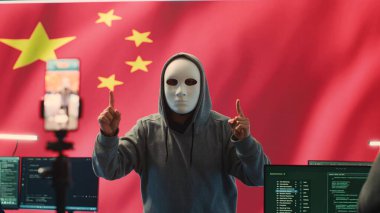 Anonymous hacker expert in a Chinese hacking high tech office, digital threats and political espionage. Inflicting cyber terror, propaganda and crisis management in information war. Camera A. clipart