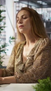 Dikey video girişimcisi önemli bir şirket iletişimi için sabit telefon görüşmesini kullanıyor. Kadın kaynak tahsisi, mali planlama ve son başvuru tarihini kendisi üzerinde çalışırken tartışıyor