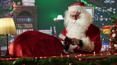 Aziz Nicholas, Kuzey Kutbu atölyesinde bir hediyeyi dikkatlice paketliyor. Noel Baba 'nın etrafa neşe saçmak için hediyeler hazırladığı festival ışıkları ve tatil sezonunun büyüsü sahneyi dolduruyor. Kamera A.