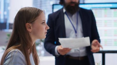 Financial adviser conducting audit of clients income to strategize plan helping them build good spending habits. Agent talking with mother and daughter, offering advice on investing, camera B clipart