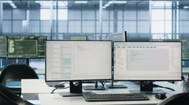 Boş yüksek teknoloji veri merkezindeki bilgisayarlar donanım enerji tüketimini izliyor. Sunucu odasındaki potansiyel sistem arızalarını ve el kamerası görüntülerini kontrol etmek için kullanılan masadaki bilgisayar monitörleri