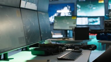 Weapons in army governmental facility used to attack enemy forces. Handguns on table in empty military base of operations with radar systems, prepared for assault mission start clipart